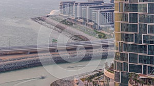 Promenade and Dubai cityscape seen from Dubai marina timelapse. Aerial view to JBR district and Bluewaters Island behind