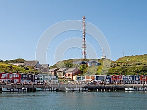 Promenade with lobster shacks at harbour of Helgoland island in North Sea, Germany