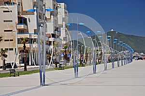 An arc of elegant street lamps on the Martil promenade. Morocco. Africa.
