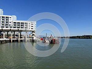 Promenade quay, hotel, restaurants and paddlewheel riverboat in New Westminster.