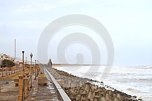 Promenade with Rocky Beach with a Temple at Distance - Devbhumi Dwarka, Gujarat, India