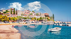 Promenade on the shore of Astros port. Sunny summer seascape of Myrtoan Sea. photo