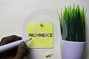 Prominence text on sticky notes isolated on office desk photo