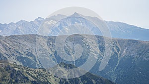 Prominentní vrchol pohoří tyčící se nad vrstvami menších hor, EU, Slovensko