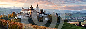 Prominent swiss style castle and houses in clear view, iconic alpine architecture photo