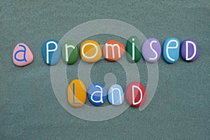 A promised land, creative motivational slogan composed with multicolored stone letters