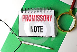PROMISSORY NOTE text on notebook on green paper