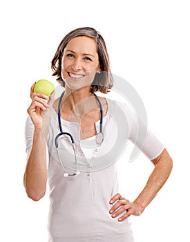 Promoting a healthy lifestyle. Cropped studio portrait of a mature female doctor holding an apple.