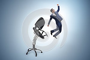 Promotion concept with businessman ejected from chair photo