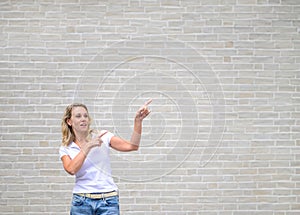 Promotional photo of a woman pointing to the right side and up