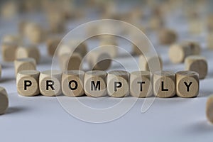Promptly - cube with letters, sign with wooden cubes photo