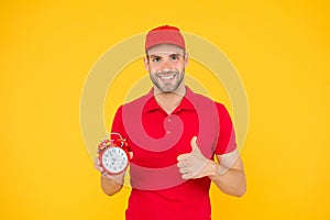 Promptness and punctuality. Delivery time. Delivery courier with clock. Delivery man holding clock. Shipping services