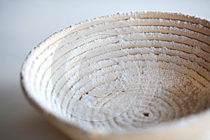 Proofing basket banetton dusted with flour photo