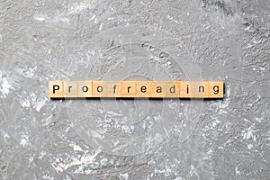 Proofreading word written on wood block. proofreading text on table, concept