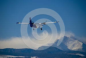 Prop Airplane Flying Over Mountains