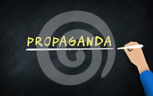 Propaganda Concept. hand writing word on chalkboard. Propaganda or promotion