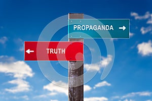Propaganda versus Truth - Road sign with two options.