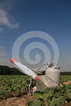 Propane cannon in a field with young crops