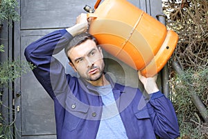 Propane tank delivery man with attractive look photo