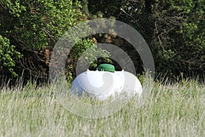 Propane Tank with green grass and trees out in the country
