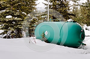 Propane Tank ina Bckyard Covered in Snow