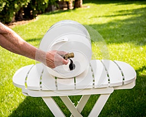Propane tank on a table with a man opening the valve