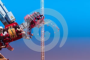 The propeller, a huge looping carousel, during a rollover in front of an oversized chain carousel at the shooting festival in Hano