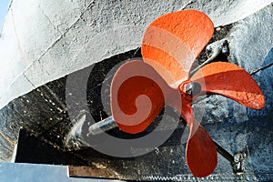 The propeller of a large, old ship. A fragment of the keel and engine mechanism of a speedboat from the Second World War. Close-up