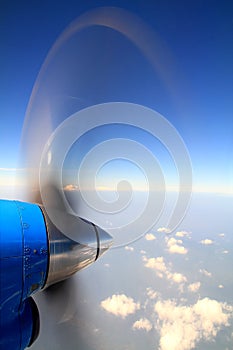 Propeller of old airplane on blue sky and clonds