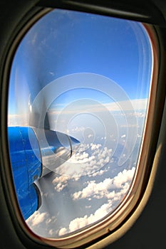 Propeller of old airplane with view of beautiful white cloud