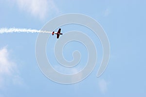 Propeller plane trailing a smoke contrail