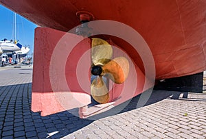 Propeller of a ship. The lower part of the ship's stern with propeller and keel. The ship is on sleepers. Dry dock