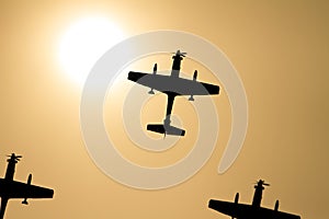 Propellor fighter Airplane silhouettes and sun