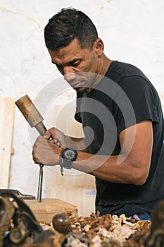 Proper handling of tools. carpenter using his tools to make pieces of wood.