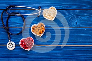 Proper nutrition for pathients with heart disease. Cholesterol reduce diet. Oatmeal, pomegranate, almond in heart shaped