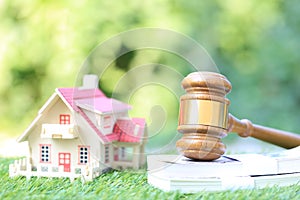 Property auction, Gavel wooden and model house on natural green background, lawyer of home real estate and ownership property