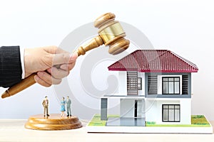 Property auction, Woman hand holding gavel wooden and model house on white background, lawyer of home real estate and ownership