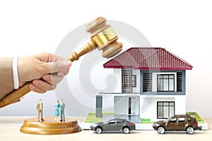 Property auction, Woman hand holding gavel wooden and model house on wtite background, lawyer of home real estate and ownership
