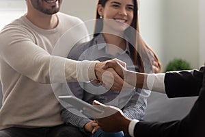Property buyer and African realtor handshaking greeting each other