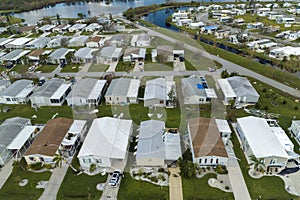 Property damage from strong hurricane winds. Mobile homes in Florida residential area with destroyed rooftops