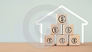 Property investment and house mortgage refinance real estate concept, dollar sign inside rotate circle on wooden cube block