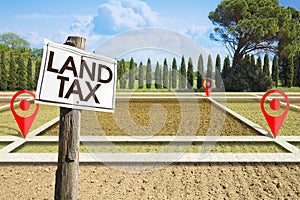Property Land Tax on vacant plot - real estate concept with a vacant land available for building construction and Land Tax text
