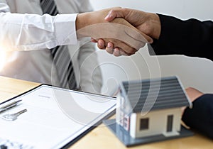 The property manager Shake hands with congratulations on the customers who bought the house with insurance,