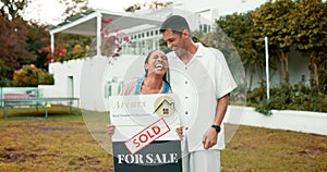 Property, real estate and a homeowner couple with a sold sign in the garden of their new house together. Love, mortgage