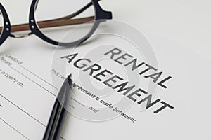 Property or real estate, house and home concept, pen and eyeglasses on rental agreement printed document, ready to sign contract