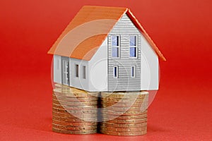 Property Tax on buildings - Property Real Estate concept with a small home model and euro coins group