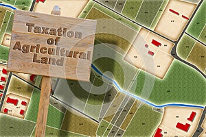 Property tax and costs on land for agricultural use - concept with an imaginary cadastral map