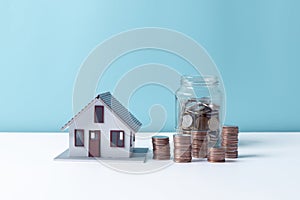 Property tax.investment planning.business real estate. View Of coin stack with house model, mortgage loading real estate property