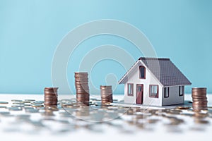 Property tax.investment planning.business real estate. View Of coin stack with house model, mortgage loading real estate property