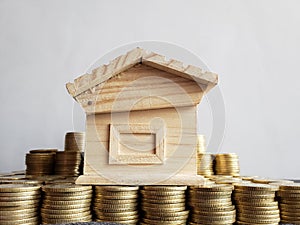 property value, stacked coins and a wooden figure of a house